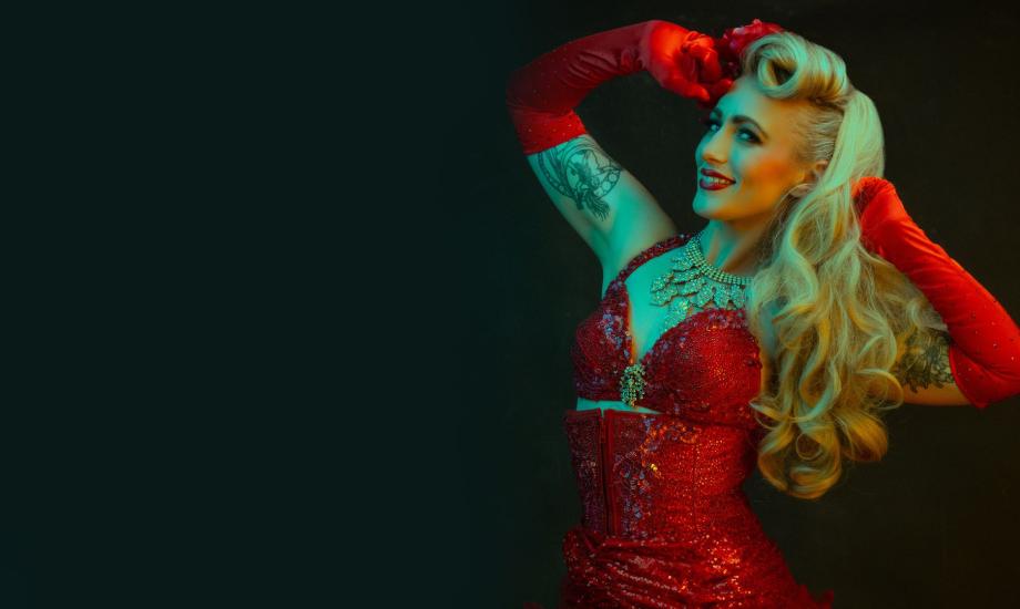 Burlesque dancer in red looks into the camera